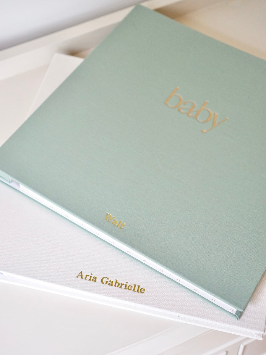 Personalised baby photo album with gold name embossing