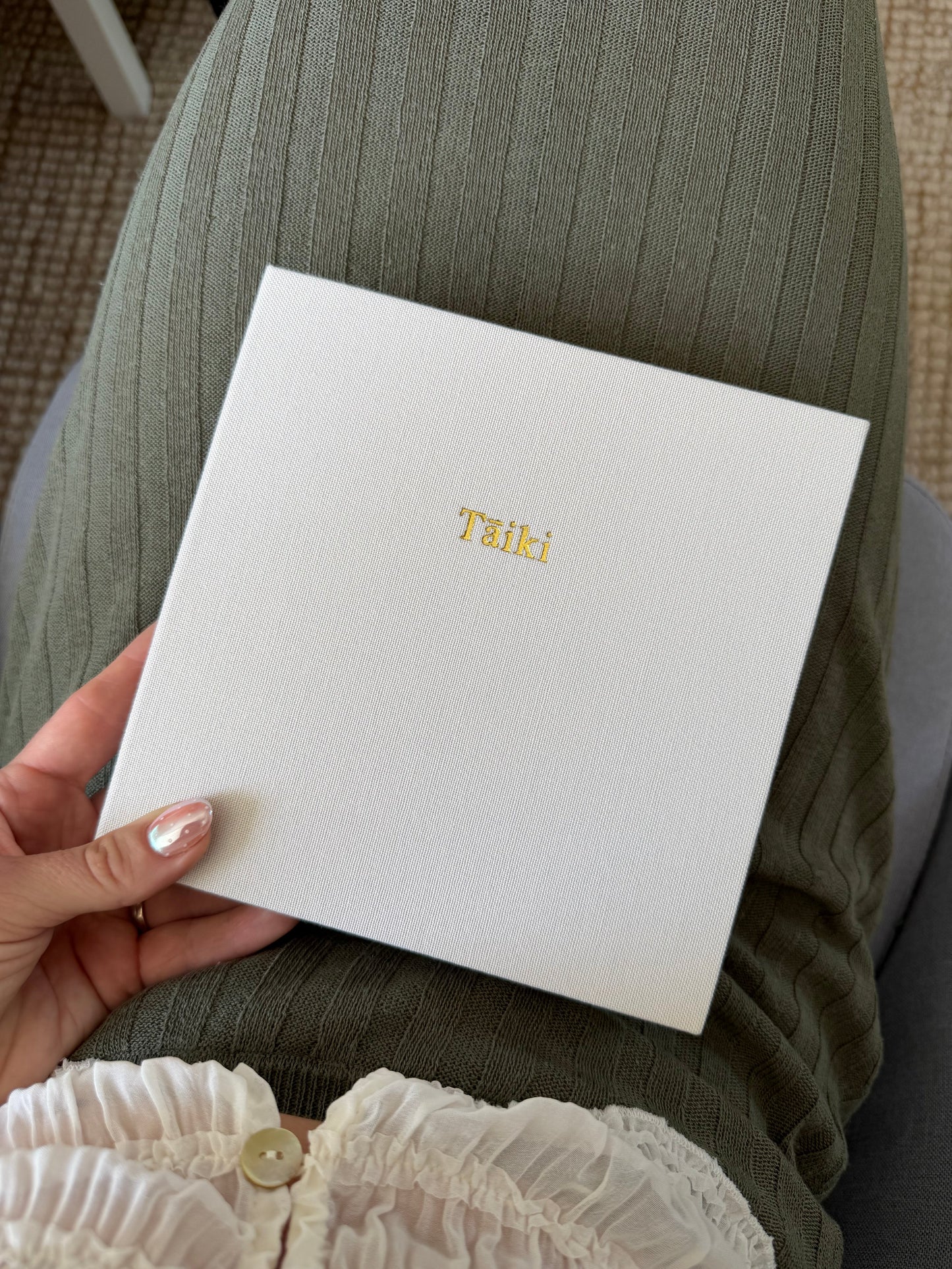 Ivory Travel Photo Album personalised in gold foil with the name Taiki, showing macron embossing